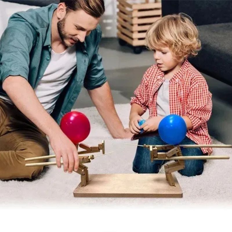 un pere et son fils partage un moment de complicité avec son fils avec un jeu de société à 2 complètement loufoque