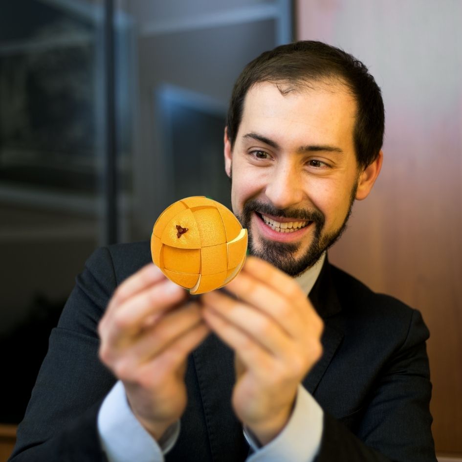 Un homme, expert des légendaires Rubik's Cube réussi le puzzle 3d orange