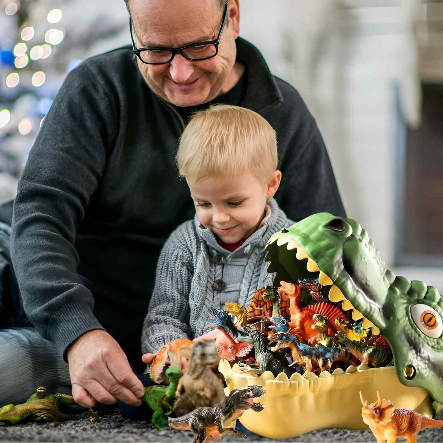 un grand-papa aimant joue avec son petit fils au dinosaure jouet du super Bac des transports des 48figurines pour le meilleur jeu dinosaure au monde