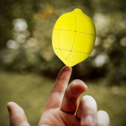 Un puzzle 3 D en forme de gros citron jaune est réussi par un enfant expert de rubik cube fruit