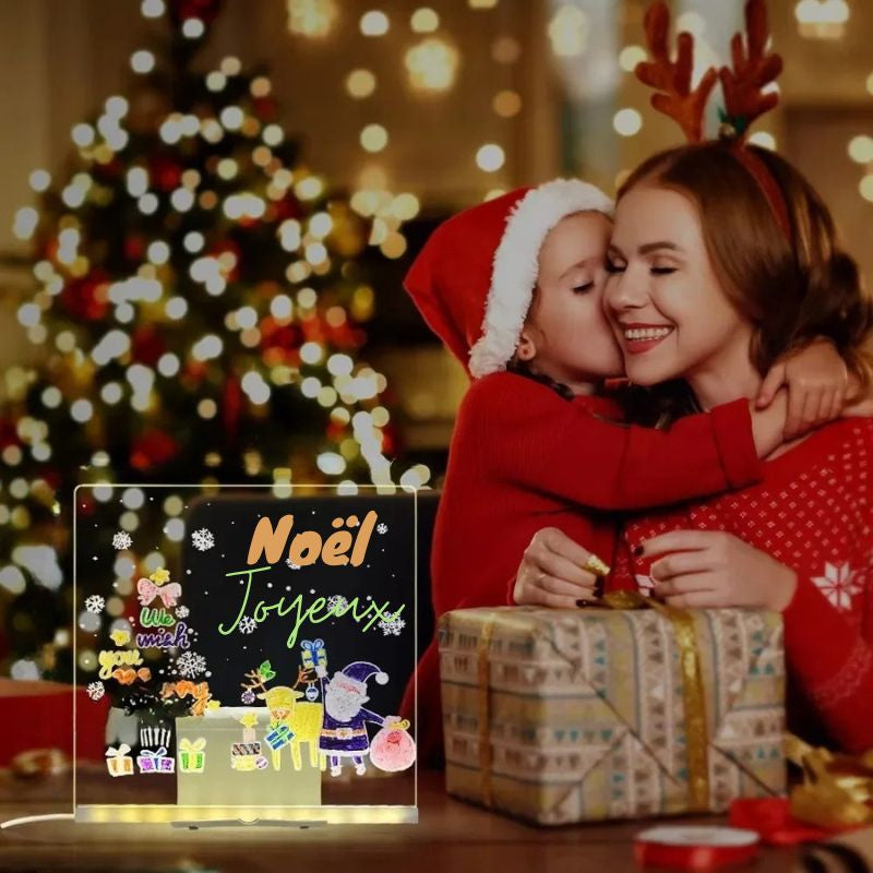 une jeun fille remerci d amour sa mere pour le cadeau de Noël qu'elle vient de recevoir le tableau lumineux à dessin 