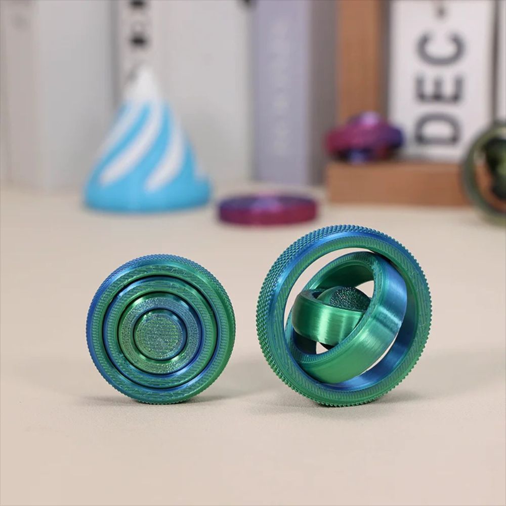 boule anti stress vert turquoise gyroscope 4 anneaux