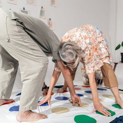 les grands-parends s'exercent au jeu de société Twister