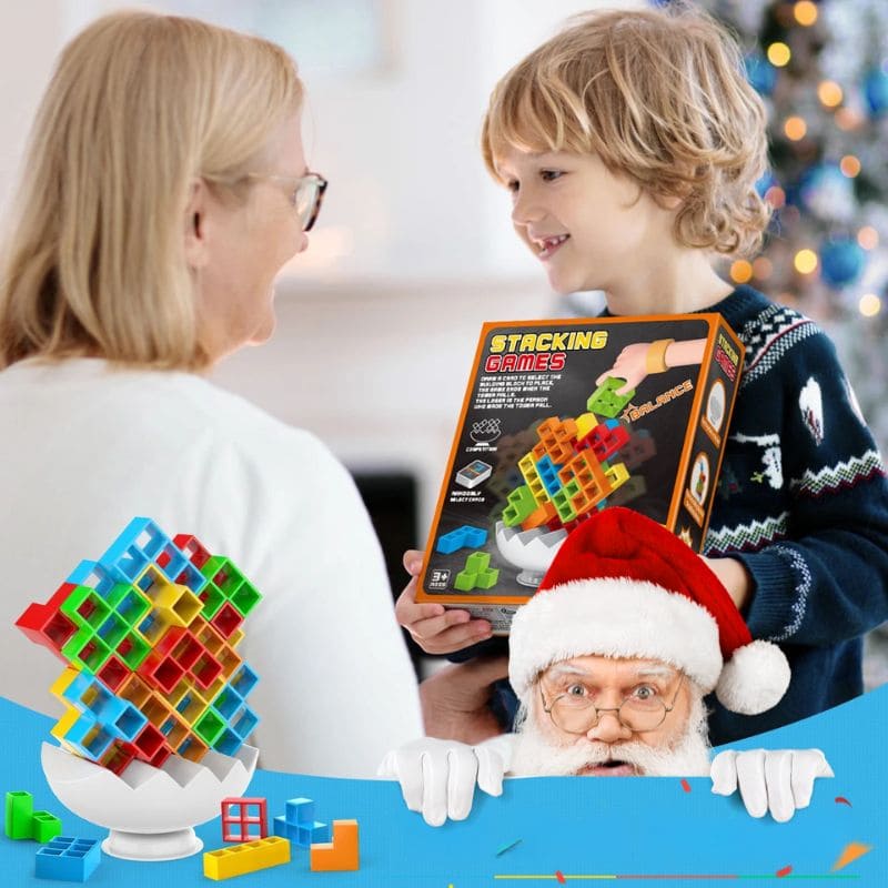 un garçon vient de recevoir un de ses cadeaux de Noël un jeu de société enfant blocs Balance, il est très content